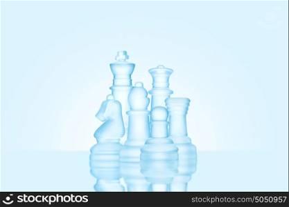 Strategy and leadership concept; frosted chess figures made of ice, standing together as a family ready for game.