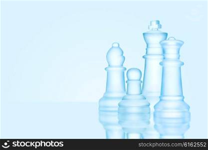 Strategy and leadership concept; frosted chess figures made of ice, standing together ready for game as on a family photo.