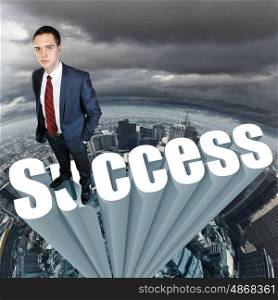 strategy. Businessman in suit standing on the word Success