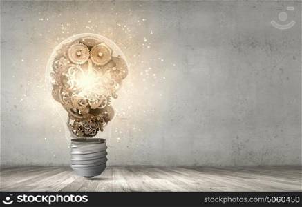 Strategy thinking. Close up of light bulb and gears mechanism