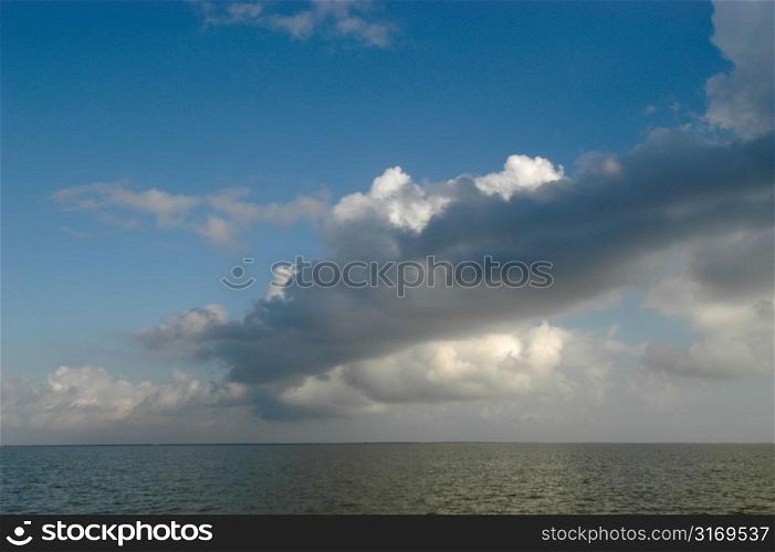 Stratified White Clouds Over The Ocean