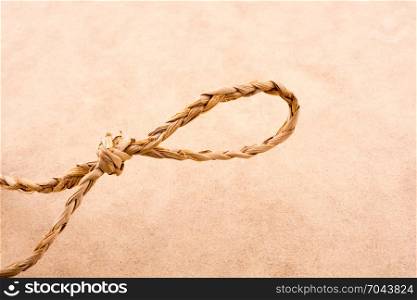 Straw tied as knot on a light color background