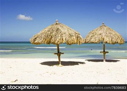 Straw umbrellas on a tropical beach