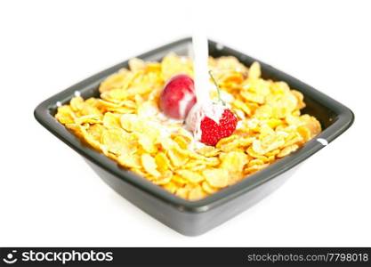 strawberries and cherries in the bowl of Cornflakes with milk isolated on white