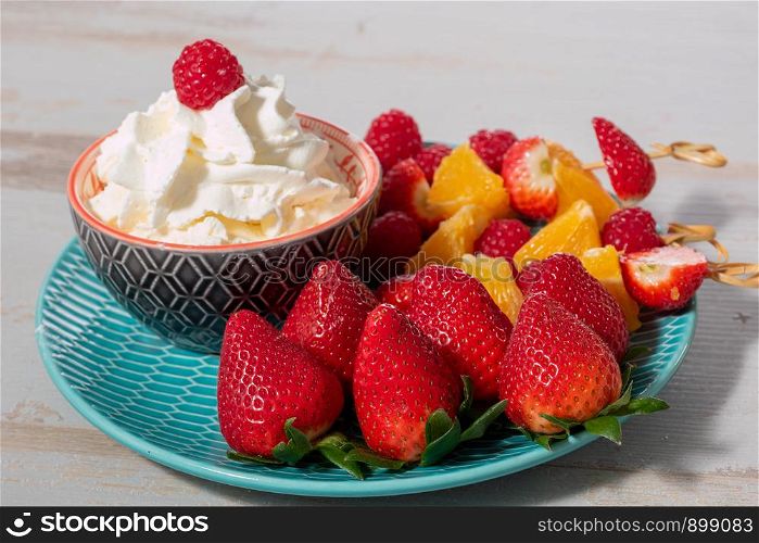 strawberries and raspberries with a whipped cream