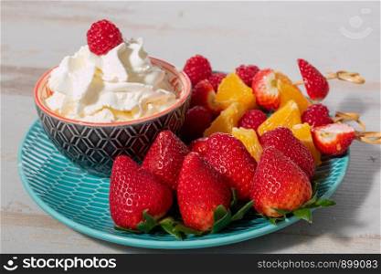 strawberries and raspberries with a whipped cream