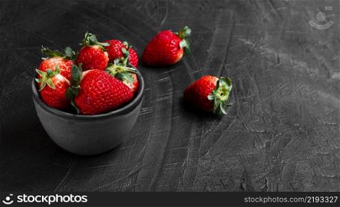 strawberries bowl black table