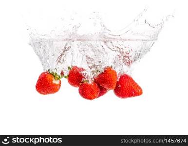 Strawberries falling into water causing bubbles all around it. Healthy food concept. White background. Strawberries falling into water causing bubbles all around it. Healthy food concept
