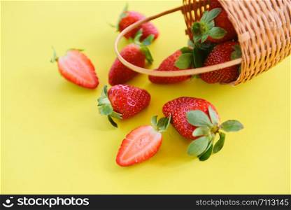strawberries fresh on yellow background / ripe red strawberry picking in basket