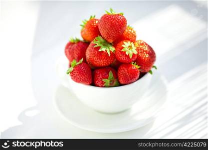 strawberries in a bowl in the daylight