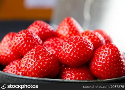 Strawberries in a bowl on a table. Studio shooting. Strawberries in a bowl