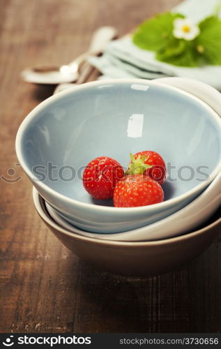 Strawberries in a Bowl on wooden background