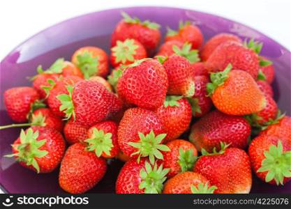 strawberries in a glass plate isolated on white