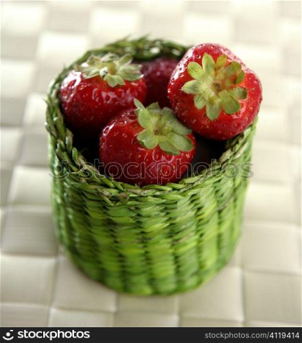 Strawberries in a green little basket