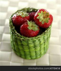Strawberries in a green little basket