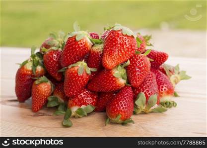 strawberries on garden’s table, outdoor picture