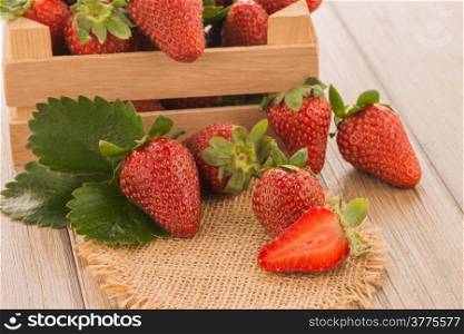 Strawberries over odl brown wooden table background