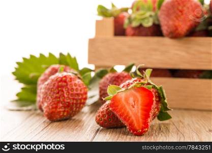 Strawberries over odl brown wooden table background