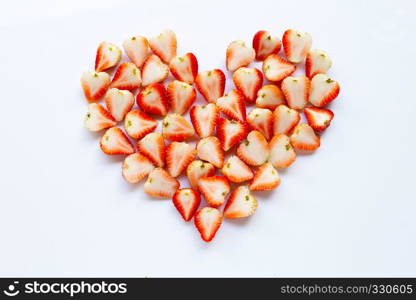 Strawberries positioned in a heart shape on white background