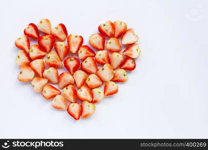 Strawberries positioned in a heart shape on white background