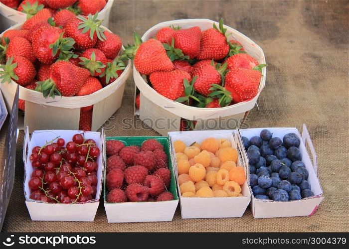 Strawberries, redcurrants and raspberries at a local French market