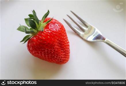 Strawberries with leaves on a plate in a glas bowl. Isolated on a white background