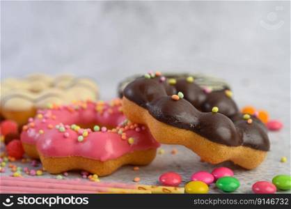 Strawberry and chocolate donuts are placed on top. Selective focus
