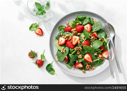 Strawberry and spinach salad with walnuts, top view