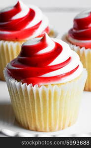 Strawberry and vanilla cupcakes on white background