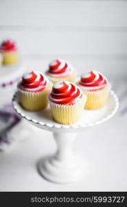 Strawberry and vanilla cupcakes on white background