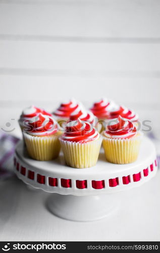 Strawberry and vanilla cupcakes on white background