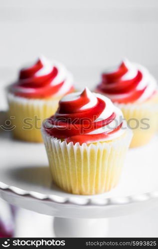 Strawberry and vanilla cupcakes on white background