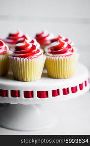 Strawberry and vanilla cupcakes on white background