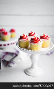 Strawberry and vanilla cupcakes on white background
