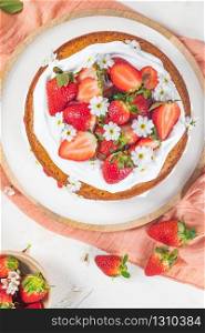 Strawberry cake, strawberry sponge cake with fresh strawberries and sour cream on a white background