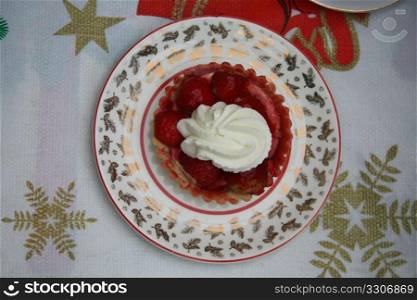 Strawberry cake with cream in a Christmas setting