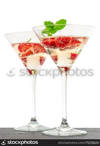Strawberry cocktail with berries in martini glass isolated on white background. Festive arrangement with sparkling wine and fresh fruits. selective focus