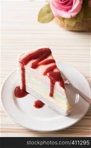 Strawberry crape cake in white plate with closeup view on wooden and ready to served in the morning.
