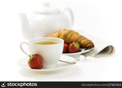 strawberry, croissant, teapot and white teacup with hot tea on white background