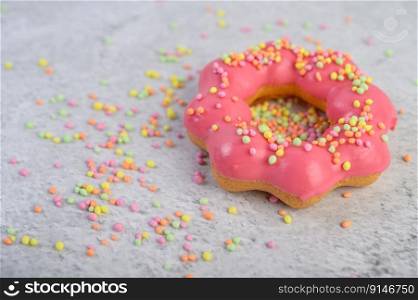 strawberry donut decorated icing and sprinkling on the floor