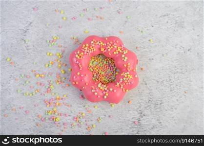 strawberry donut decorated icing and sprinkling on the floor