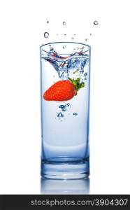 Strawberry dropped into water glass with splash isolated on white