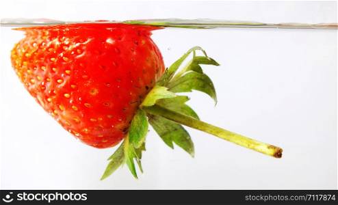 Strawberry falling in water of thailand