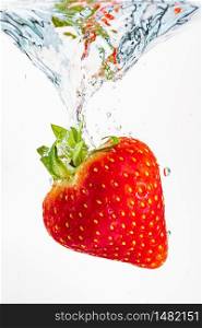 Strawberry falls deeply under water with a big splash. Fruit sinking in clear water on white background. Antioxidant concept. Strawberry falls deeply under water with a big splash. Fruit sinking in clear water on white background