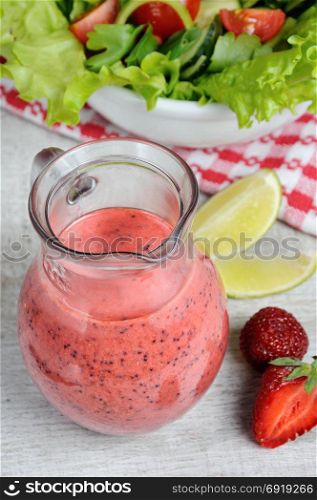 Strawberry fresh sauce with mint, poppy and lime in a glass sauceboat