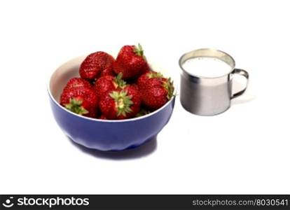 strawberry in a blue soup plate and a milk mug, a berry subject