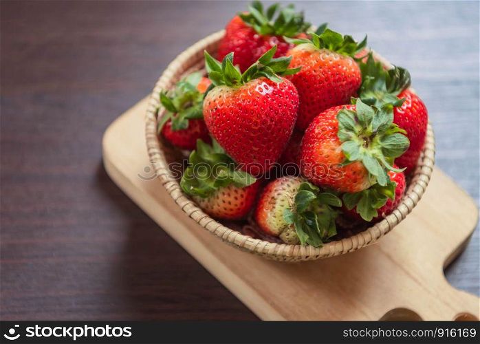 Strawberry in basket on wooden table. Fruit and vegetable concept. Freshness snack and low calories for dieting with plenty of Vitamin C