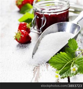 Strawberry jam in a jar on wooden background