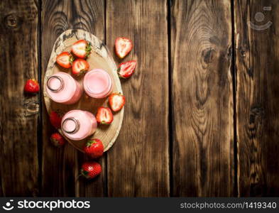 Strawberry juice on a tray. On wooden background.. Strawberry juice on a tray.