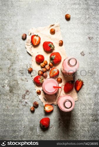 Strawberry juice with nuts on the old fabric. On the stone table.. Strawberry juice with nuts on the old fabric.